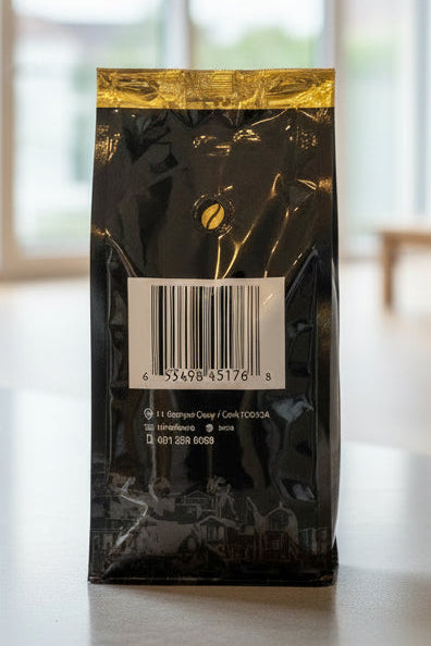 Black coffee bag with a reflective label on a light grey background