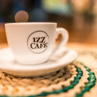 Izz Cafe coffee cup with a saucer - Izz Cafe